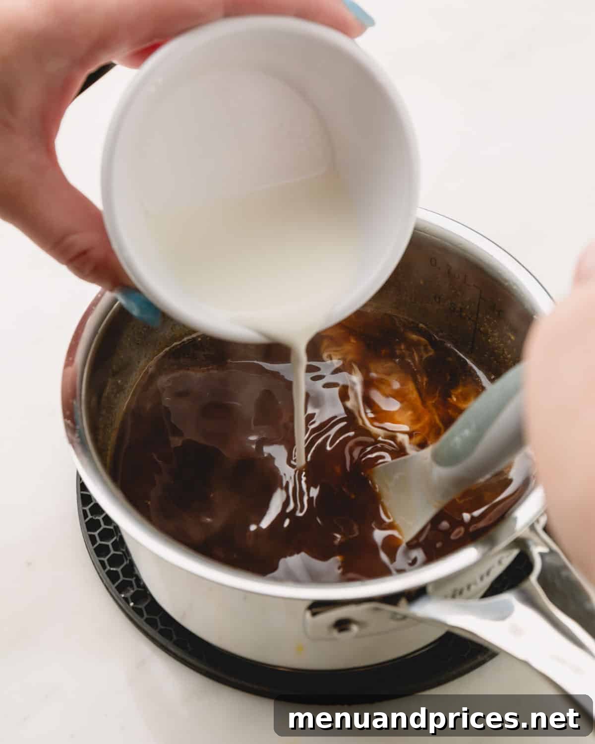 Sticky Teriyaki Chicken Wings 10 A cornstarch slurry being slowly poured into a pot of bubbling honey teriyaki sauce, illustrating the thickening process.