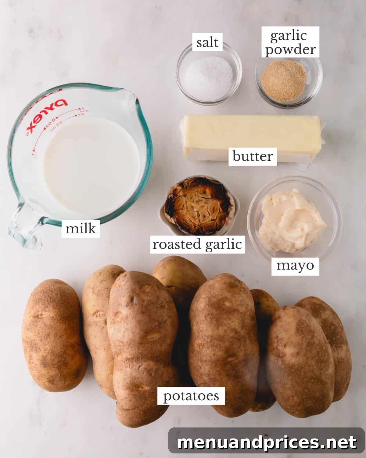 Garlic Infused Potato Perfection 3 A vibrant display of fresh ingredients: Russet potatoes, garlic, milk, butter, and seasonings for roasted garlic mashed potatoes.