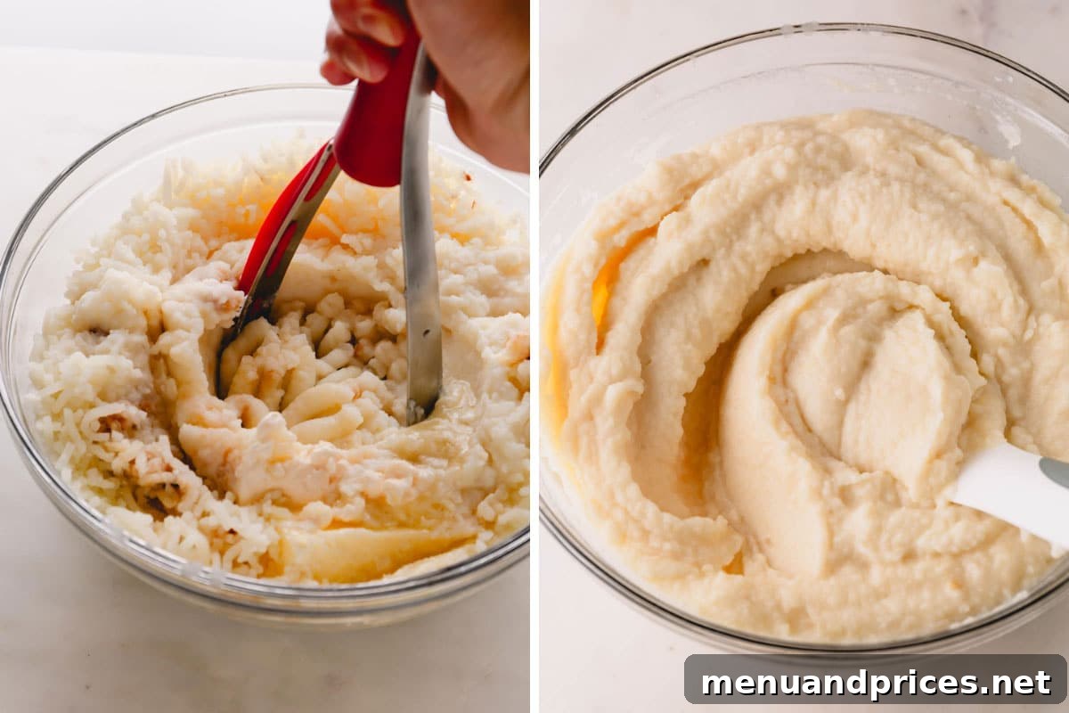 Garlic Infused Potato Perfection 7 A hand expertly using a potato masher in a pot of freshly made, fluffy roasted garlic mashed potatoes.