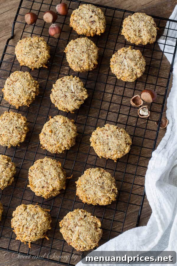 Toasted Hazelnut Coconut Delights 4 Freshly baked hazelnut coconut cookies cooling on a rack, highlighting their golden-brown edges.