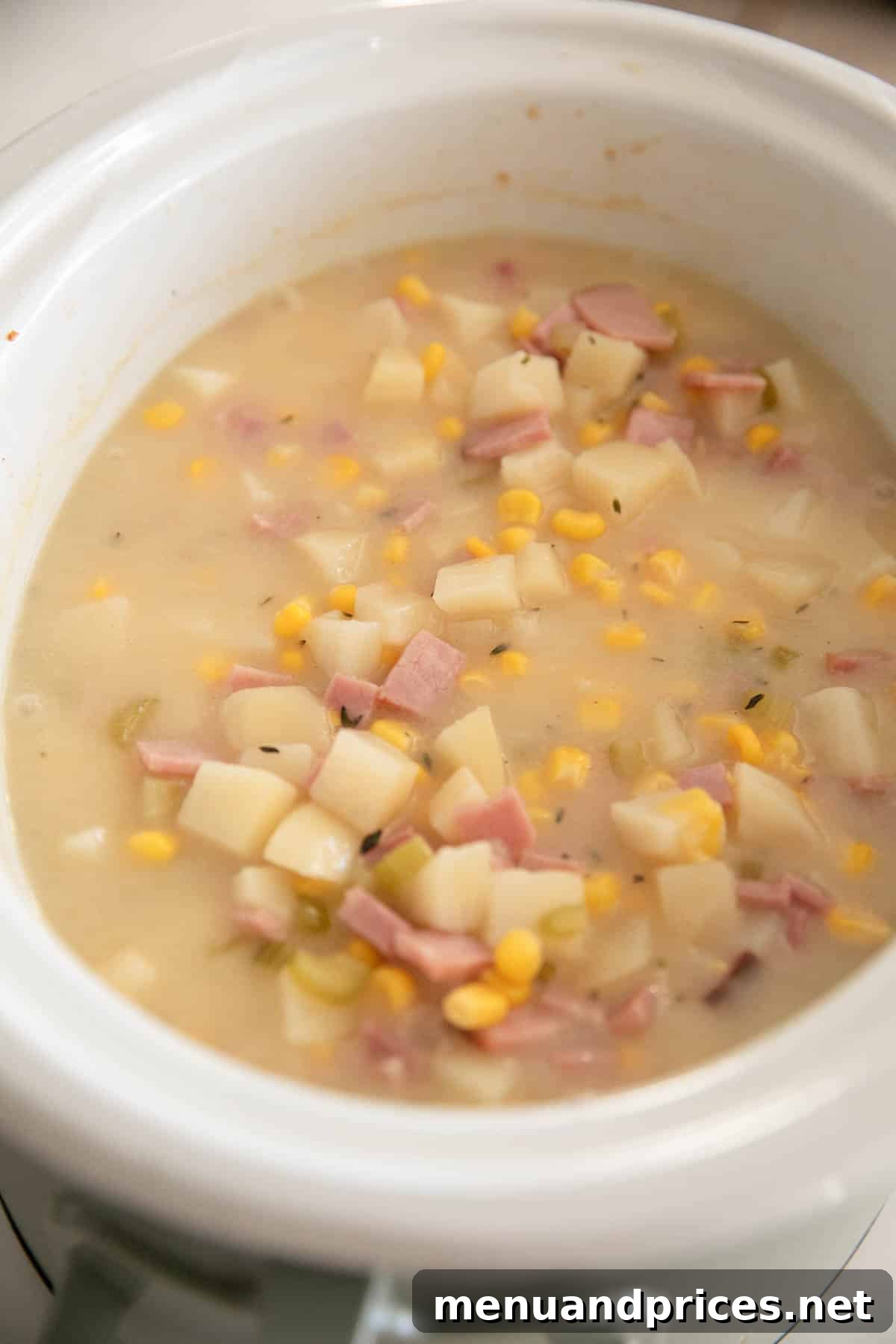 Hearty Slow Cooker Ham and Potato Chowder 7 Slow cooker ham and potato soup in a slow cooker.