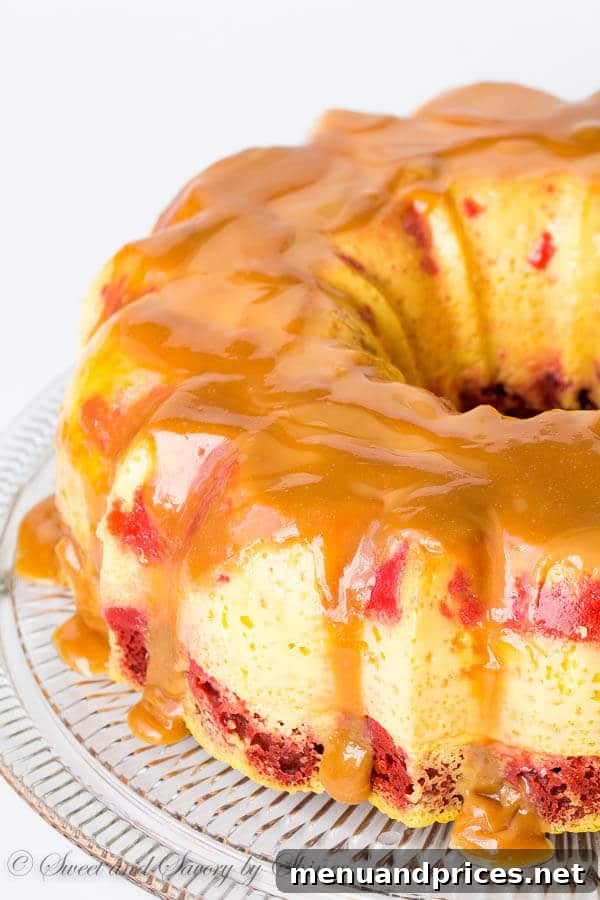 Close-up of a slice of Magic Red Velvet Flan Cake revealing the distinct red cake, white flan, and golden caramel