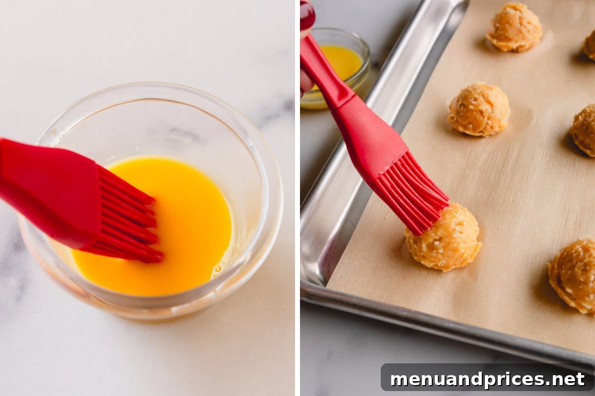 Fluffy Havarti Cheese Gougères 10 Side-by-side images of an egg wash in a bowl and a pastry brush applying it to cheese puff dough on a baking sheet.
