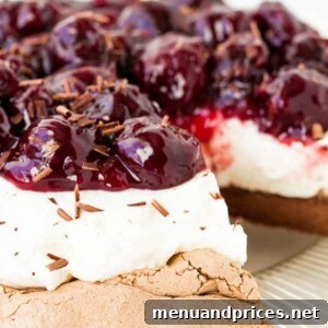 Cherry Chocolate Pavlova with whipped cream and cherry sauce