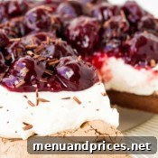 A delicious slice of Cherry Chocolate Pavlova ready to be enjoyed.