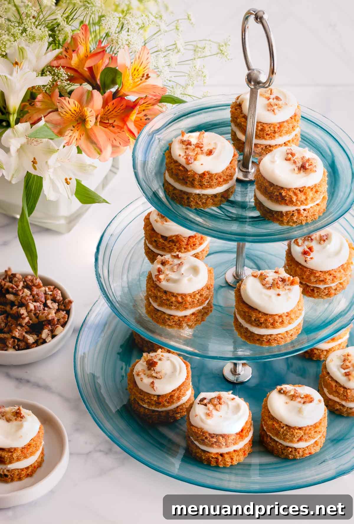 An elegant array of mini carrot cakes beautifully arranged on a three-tier platter, perfect for a party or special event.