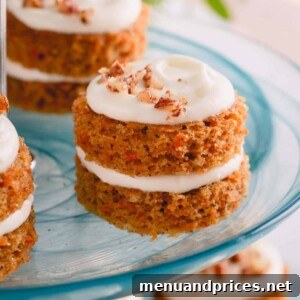 Exquisite mini carrot cakes with candied pecans, elegantly presented on a platter.