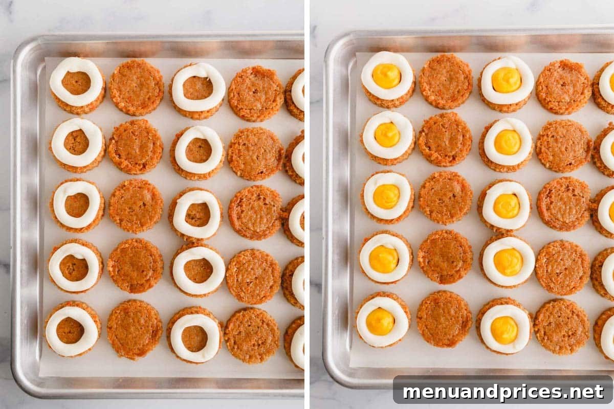 Carrot cake rounds with cream cheese frosting piped around the edges, some filled with bright pineapple curd, ready for the top layer.