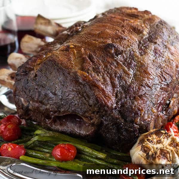 A close-up of a prime rib roast, seasoned and ready for the oven, showcasing the marbling.
