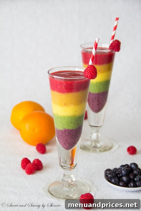 Refreshing Spring Dishes Bursting with Flavor 13 Visually stunning rainbow smoothie with layered colorful fruits, a special occasion drink.