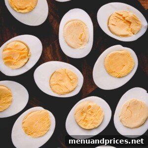Perfectly Peelable Farm Fresh Eggs 7 Halved hard boiled eggs on a cutting board.