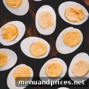 Perfectly Peelable Farm Fresh Eggs 8 Halved hard boiled eggs on a cutting board.