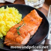 Chef preparing pan-fried steelhead trout with lemon thyme butter sauce