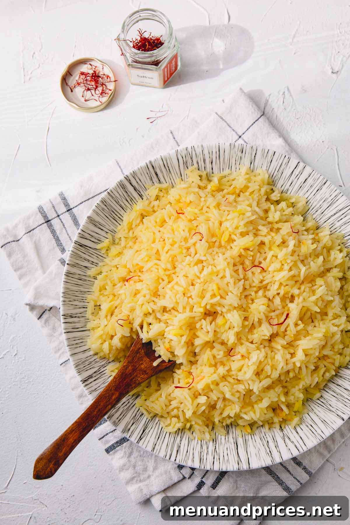 Sun-Drenched Saffron Rice 2 Saffron Rice on plate with wooden spoon