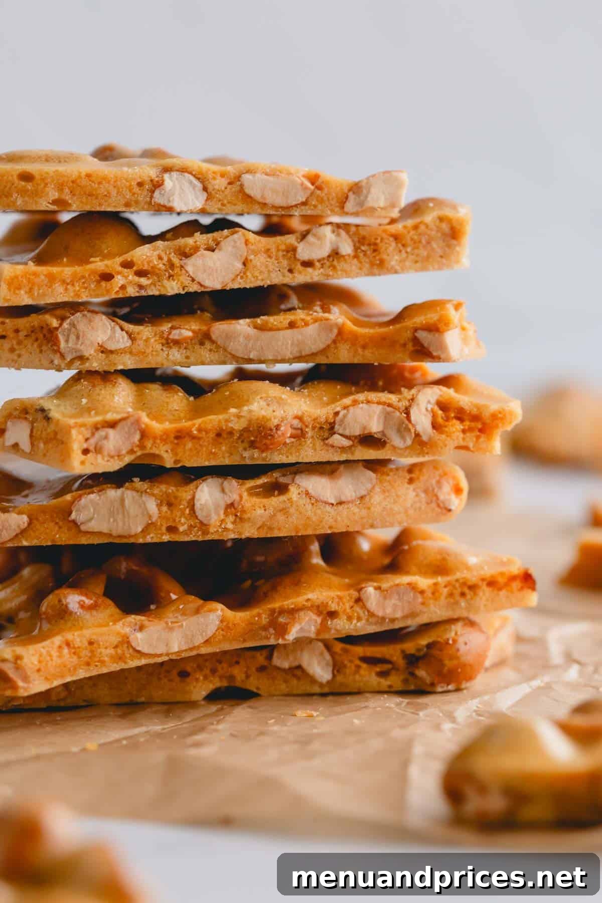 A beautifully arranged stack of homemade peanut brittle pieces, showcasing their perfect texture.