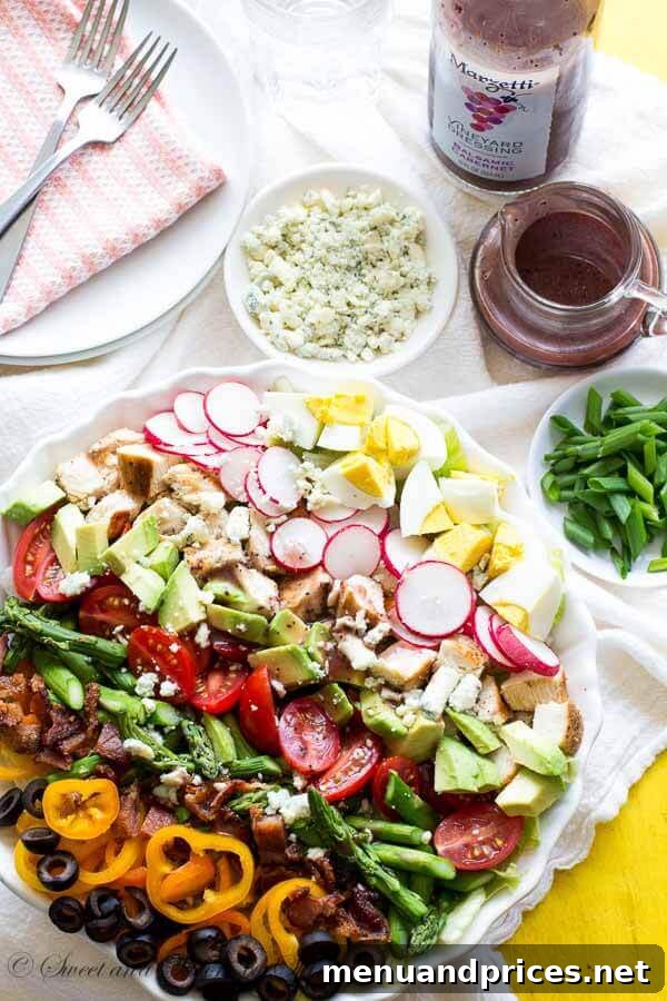 Close-up of Marzetti Vineyard Balsamic Cabernet Dressing drizzled over a fresh Cobb Salad