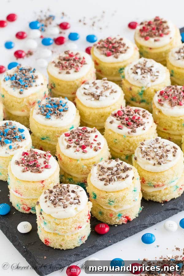 Close-up of a stack of funfetti mini layer cakes, showcasing their moist texture and colorful sprinkles within the cake layers, ready to be enjoyed