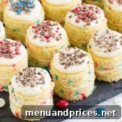 An assortment of Funfetti Mini Layer Cakes arranged artfully, viewed from a top-down perspective, highlighting their colorful decorations