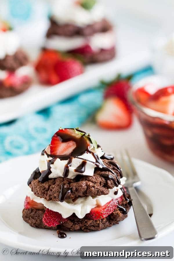 Velvet Berry Chocolate Stacks 7 Stacked chocolate strawberry shortcakes with a generous amount of whipped cream and a decadent chocolate sauce drizzle