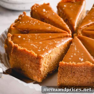 sliced dulce de leche cheesecake on a white serving platter.