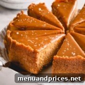 sliced dulce de leche cheesecake on a white serving platter.