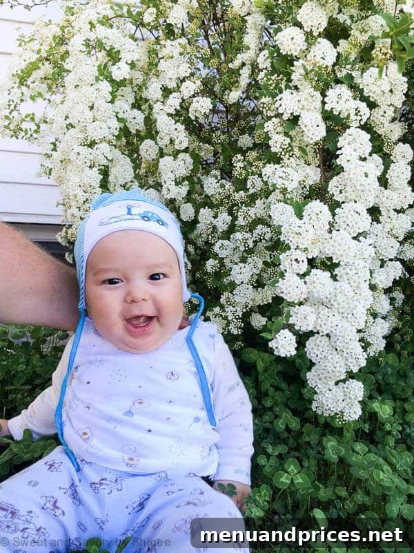 Grant's World at Five Months 2 Grant, a 5-month-old baby, smiling in a beautiful setting, capturing his adorable personality and growth.