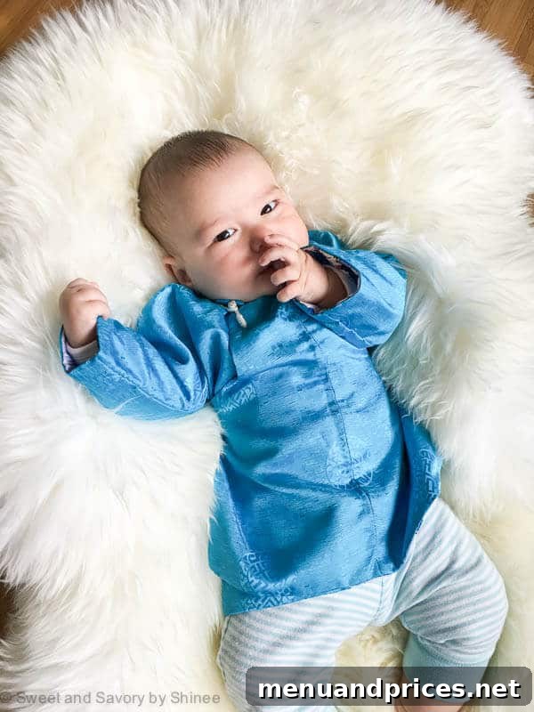 Grant's World at Five Months 3 Grant, a 5-month-old baby, dressed in a traditional Mongolian outfit, showcasing his heritage and cute demeanor.