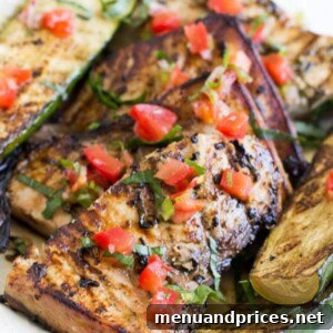Lime Basil Grilled Swordfish Steaks plated with grilled zucchini.