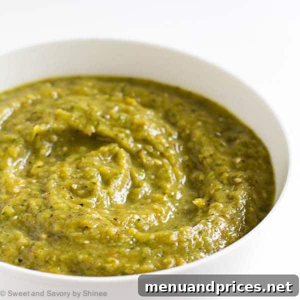 Ember-Kissed Tomatillo Salsa 5 A vibrant bowl of charred tomatillo salsa verde, ready to be enjoyed as a dip or condiment.