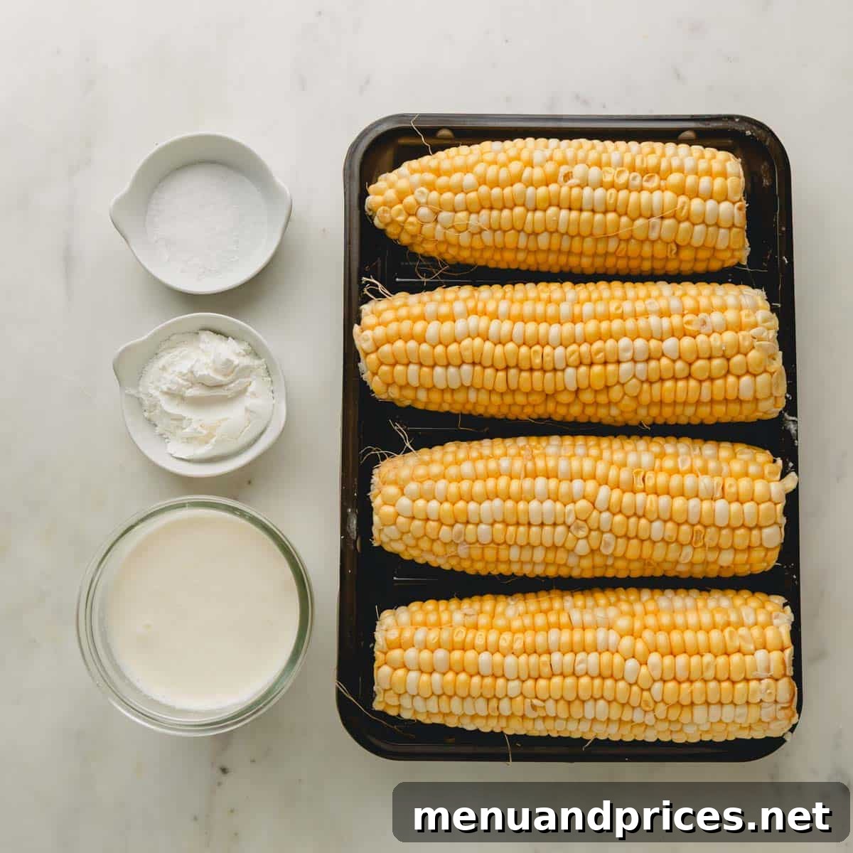 Effortless Creamed Corn 3 A simple array of ingredients for creamed corn: fresh corn, heavy cream, and cornstarch.