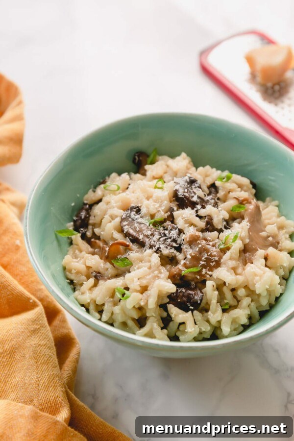 Easy Creamy Instant Pot Mushroom Risotto 5 A serving of mushroom risotto garnished with fresh herbs and a drizzle of olive oil.