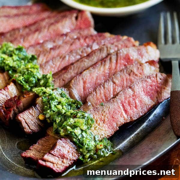 Grilled Ribeye Perfection with Fresh Chimichurri 5 Grilled ribeye steak sliced and garnished with chimichurri sauce, showcasing its juicy interior