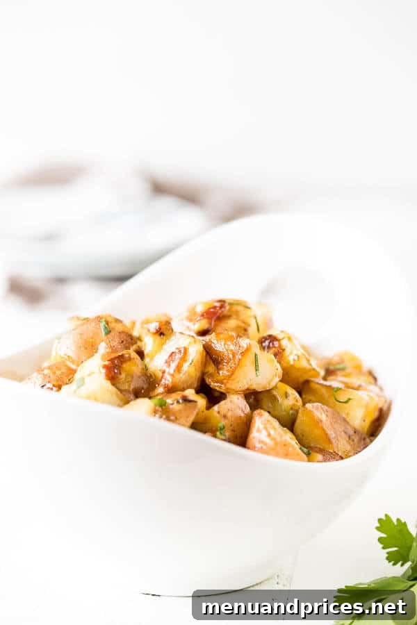 Crispy Ranch Potatoes in Instant Pot 5 Side view of Instant Pot Bacon Ranch Potatoes in a serving bowl, garnished with herbs