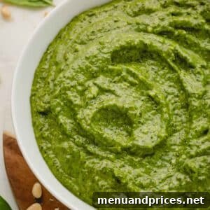 A bowl of large batch basil pesto, close-up.