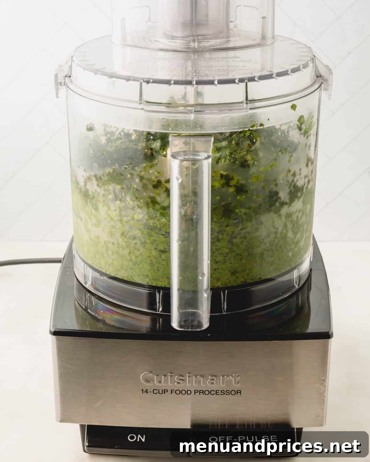 Big Batch Basil Pesto: A Freezer-Friendly Recipe 10 Basil pesto being processed into a smooth green paste in a food processor.