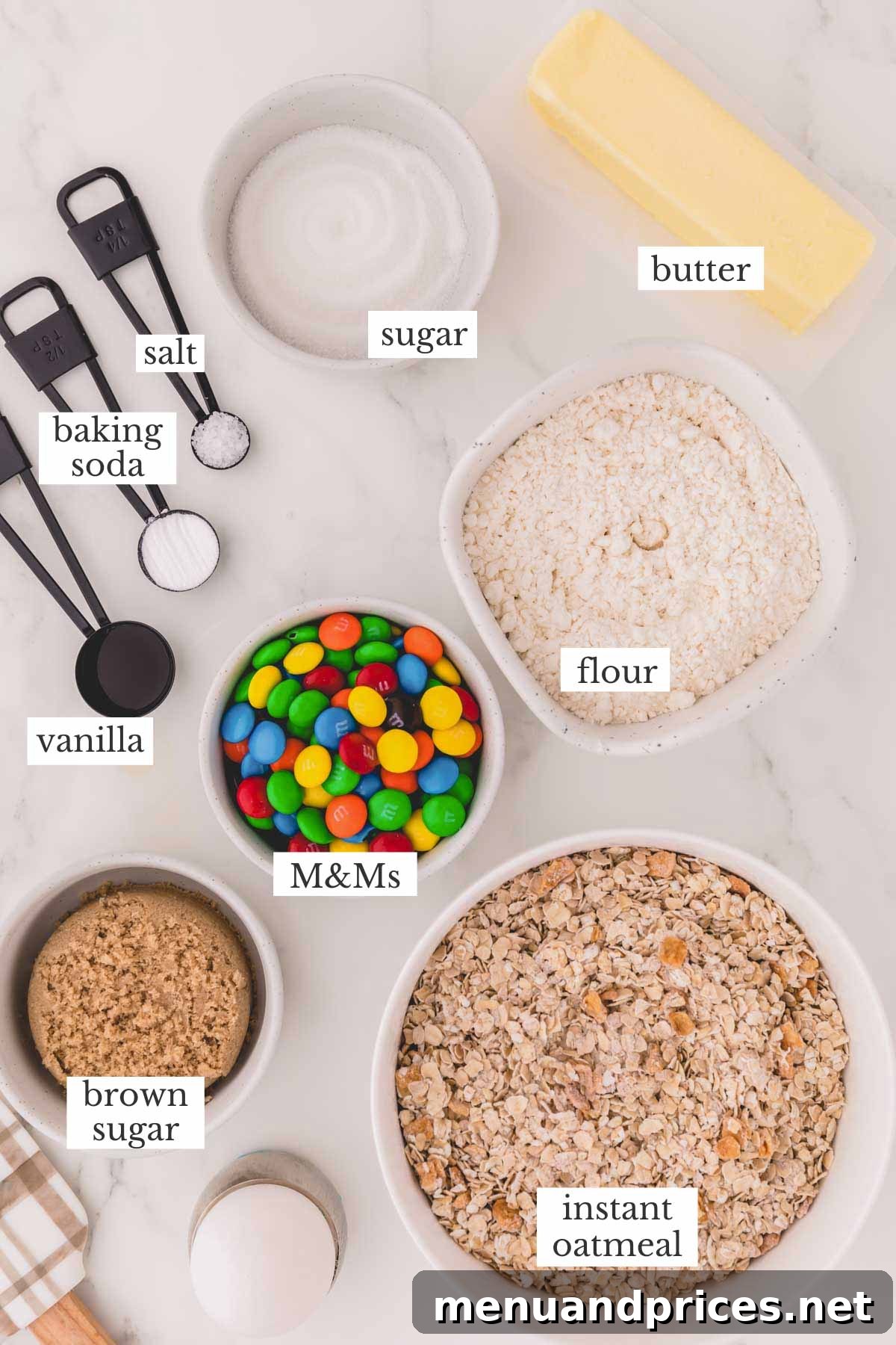 A flat lay photograph showcasing all the fresh and packaged ingredients laid out on a clean surface, ready for making apple cinnamon oatmeal cookies.