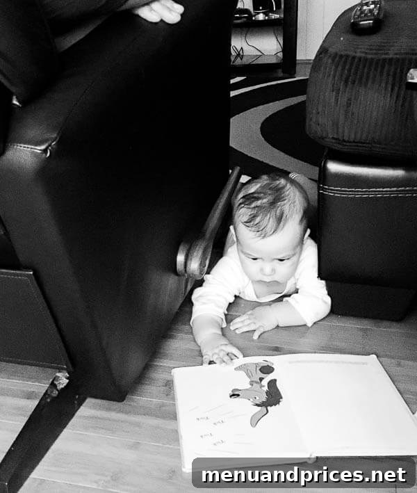 baby G happily playing on the floor with toys
