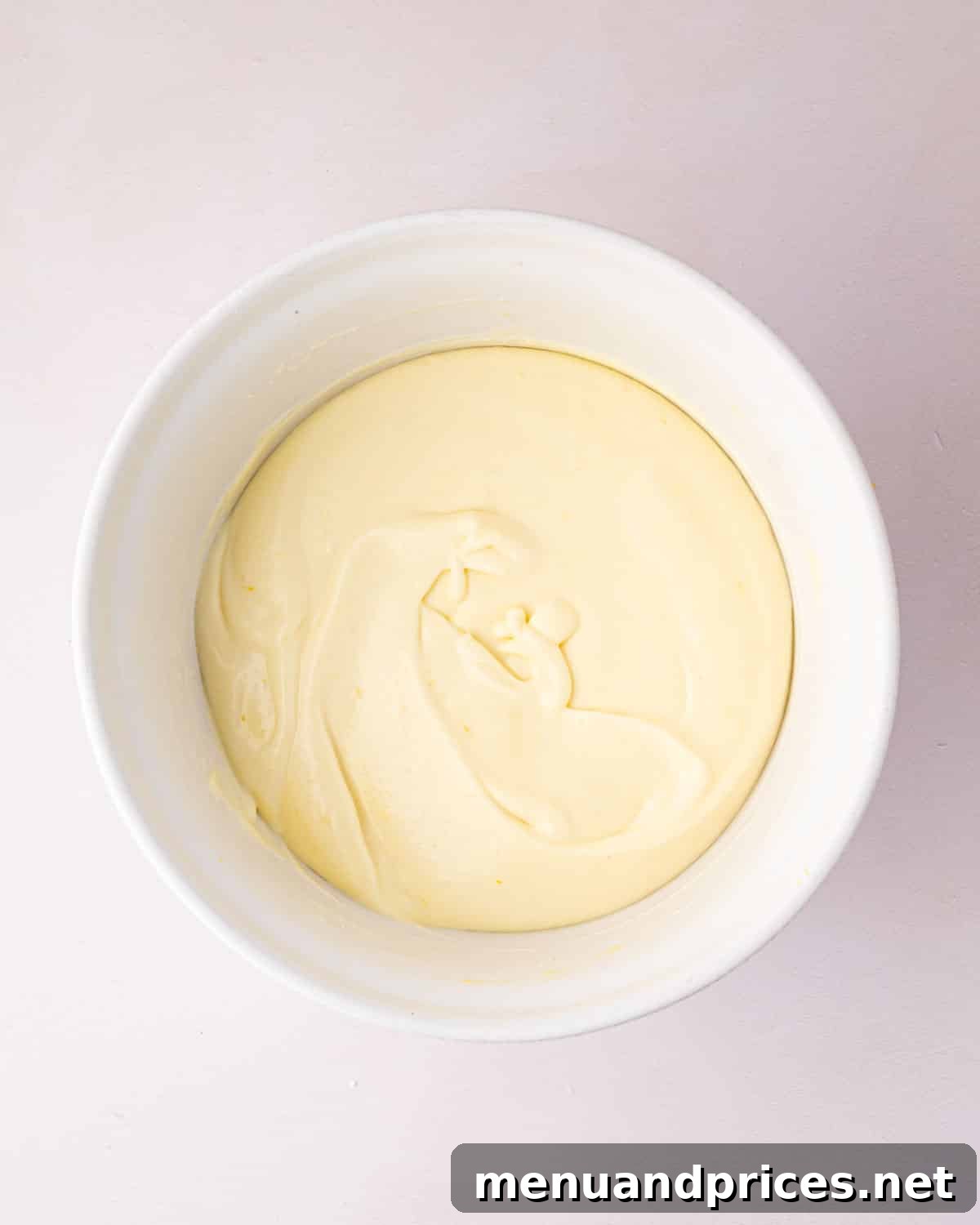 Zesty Lemon Dream 17 A white bowl with thickened lemon mousse.