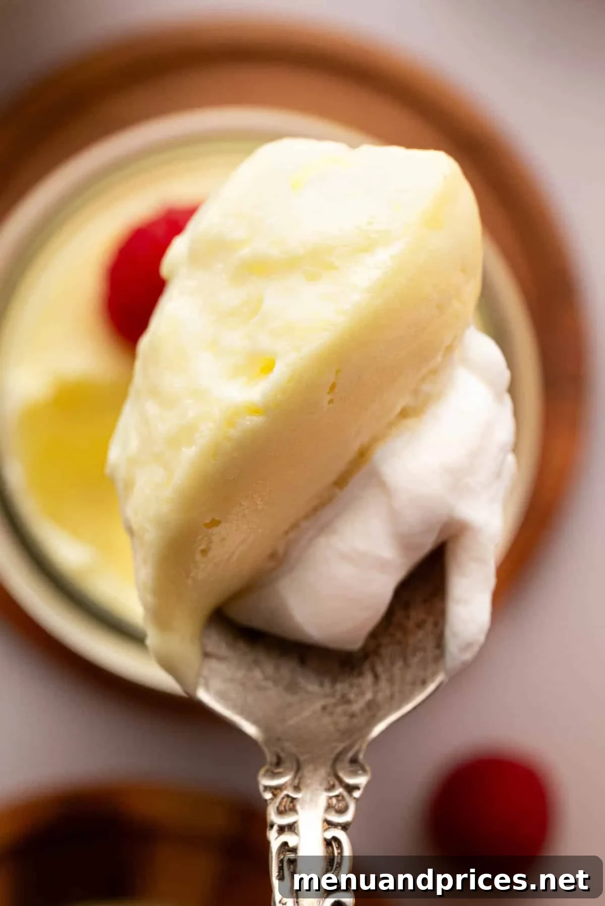 Zesty Lemon Dream 20 A spoon with lemon mousse and whipped cream.