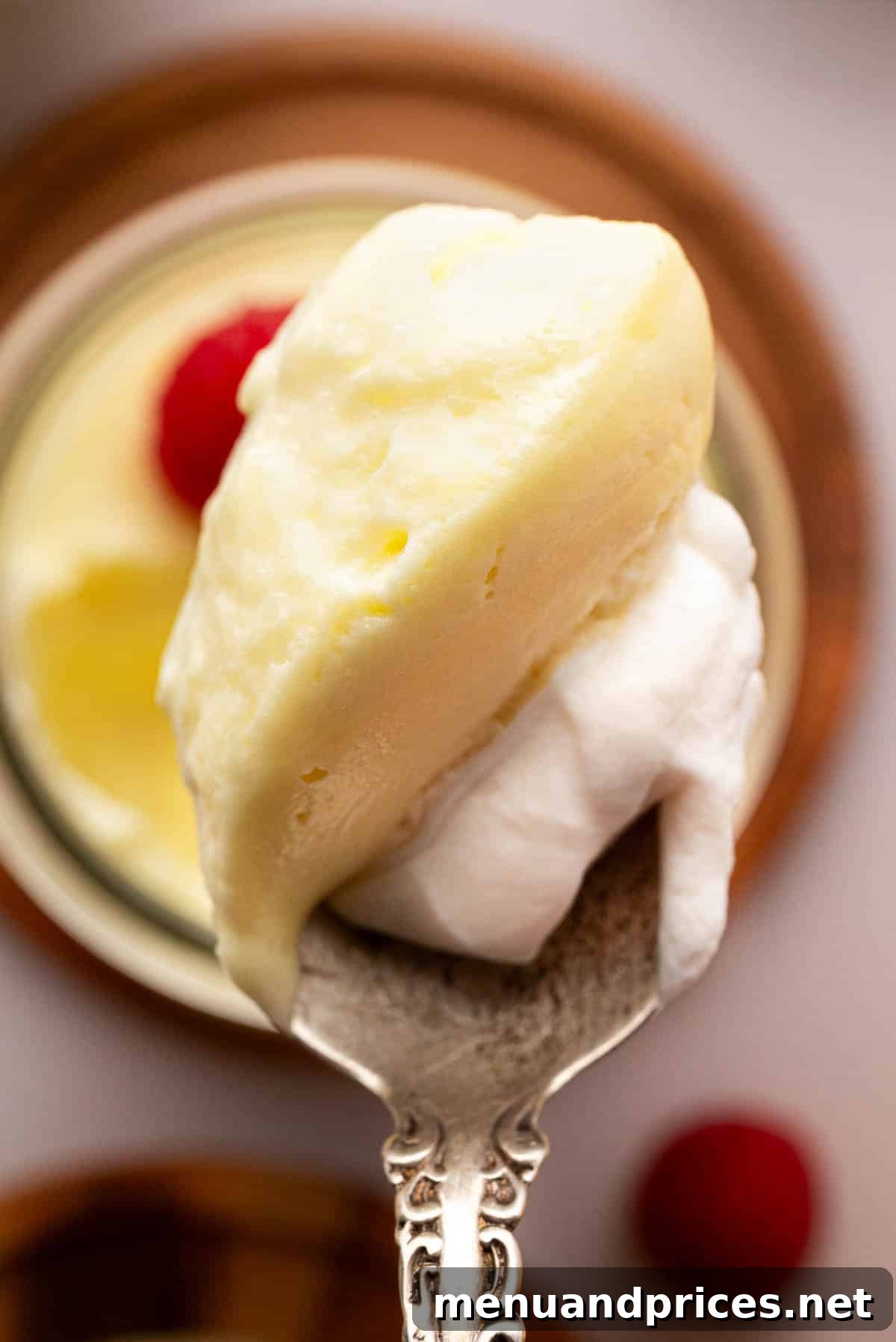 Zesty Lemon Dream 4 A spoon with lemon mousse and whipped cream.