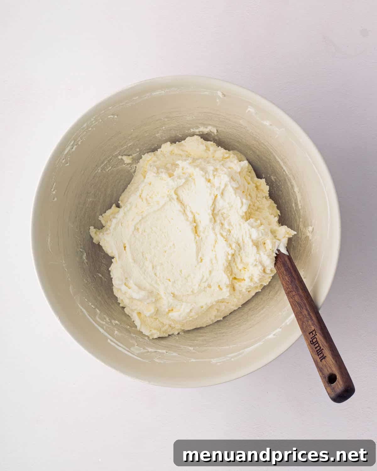 Bright Citrus Tiramisu 14 The final light and fluffy mascarpone whipped cream mixture in a white bowl, ready for assembly.