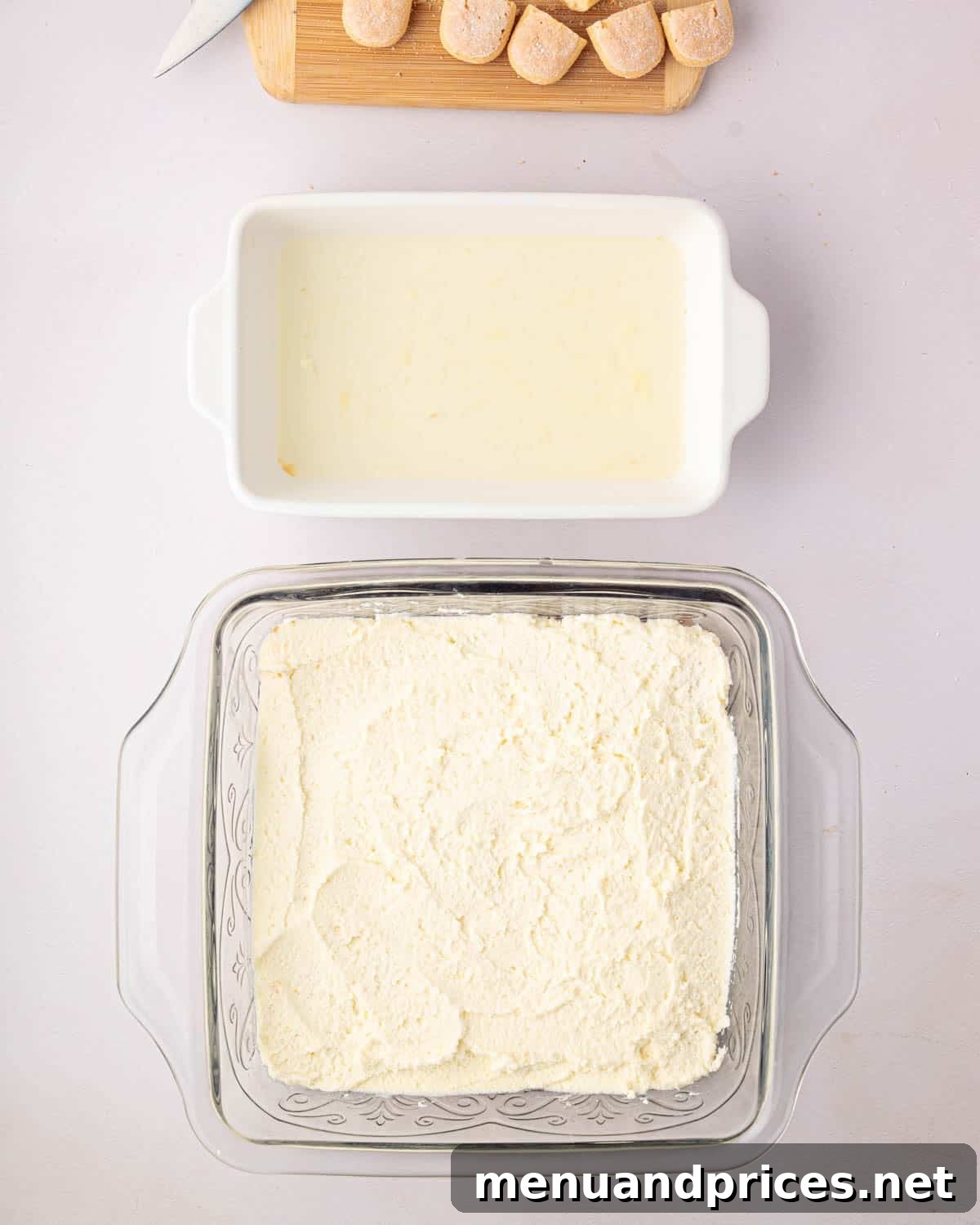 Bright Citrus Tiramisu 17 A glass baking dish with a layer of soaked ladyfingers topped with a smooth layer of mascarpone whipped cream.