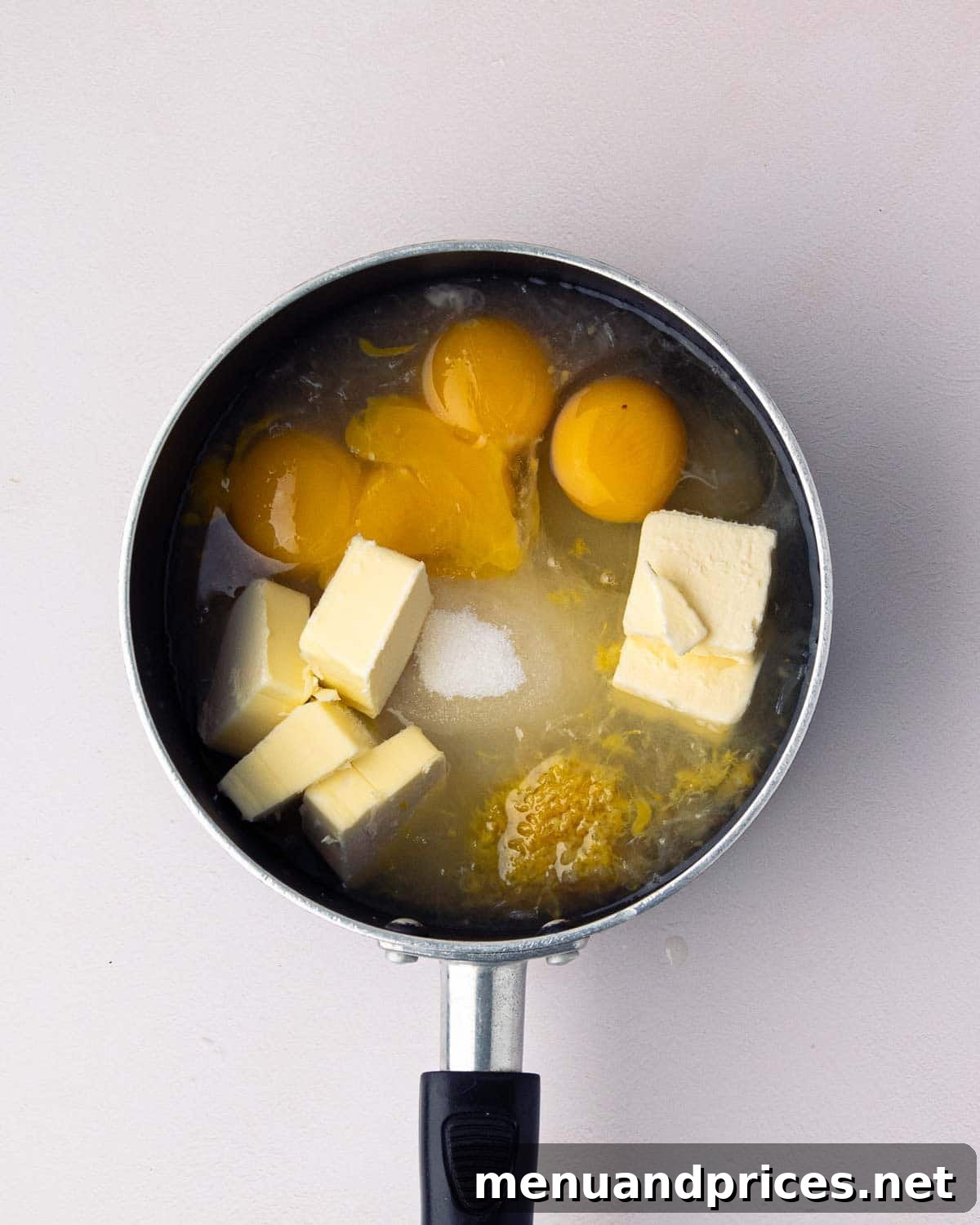 Bright Citrus Tiramisu 5 A saucepan filled with the initial ingredients for lemon curd, ready for cooking.