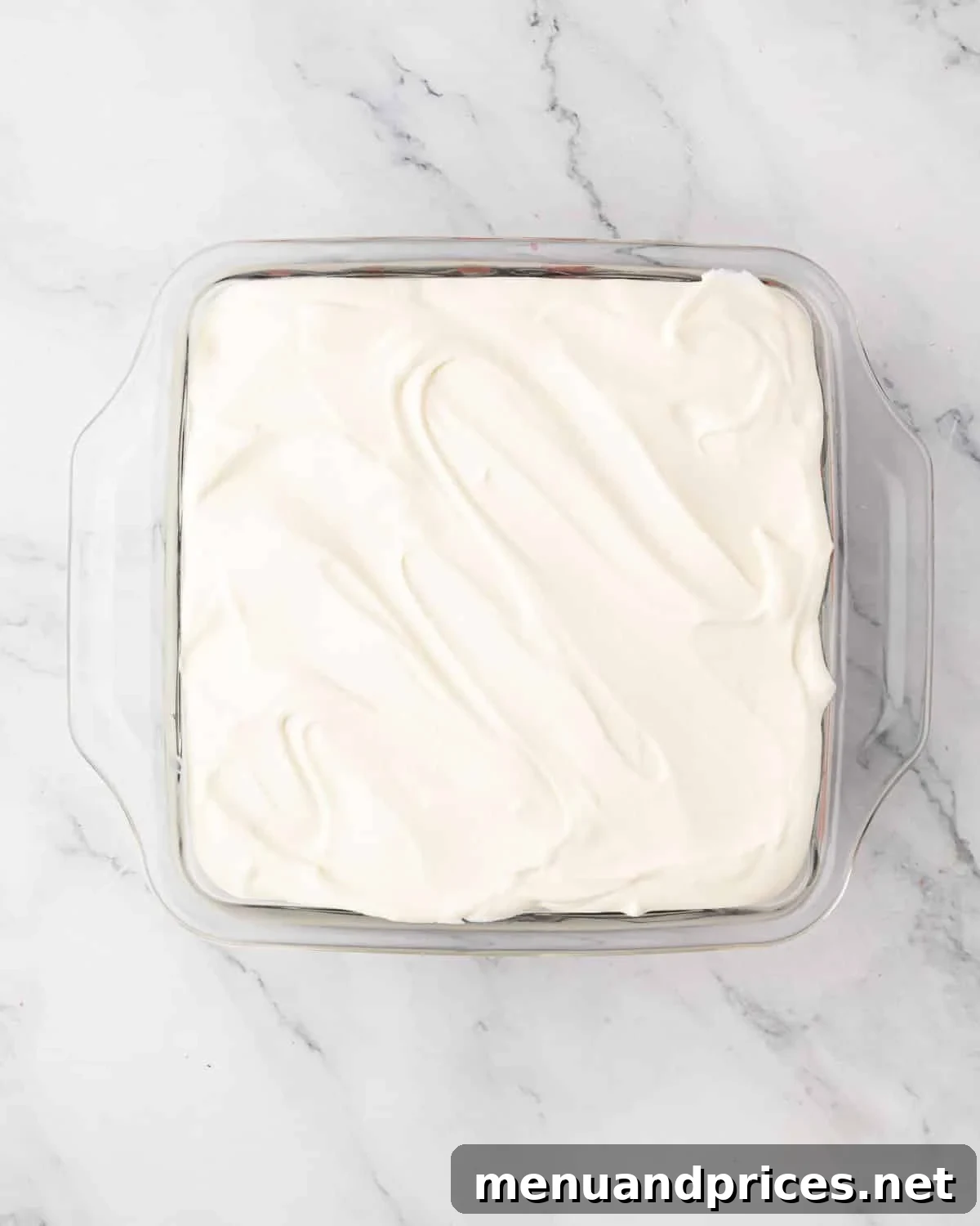 The final layer of smooth mascarpone cream applied, ready for chilling and garnishing.