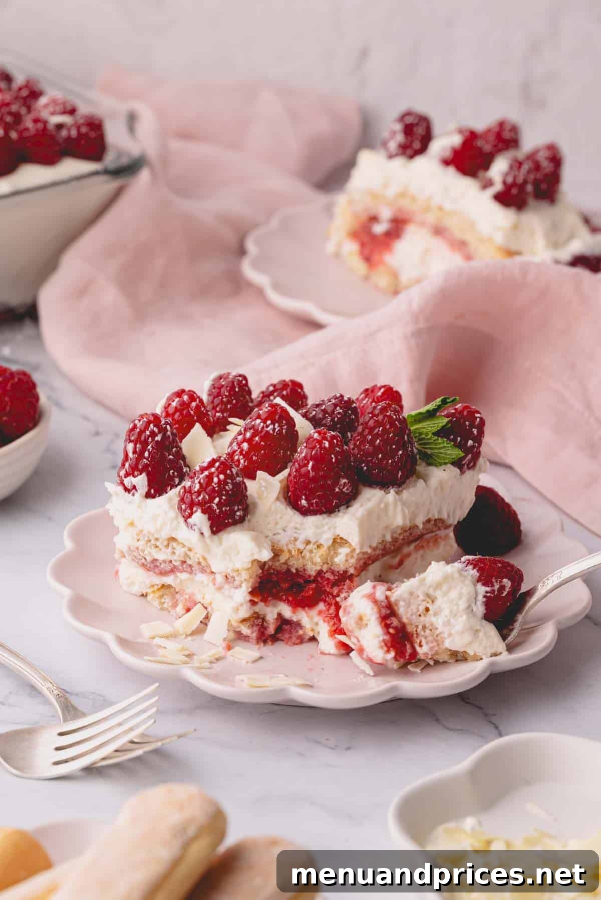 Close-up shot of the creamy layers of raspberry tiramisu, ready to be served.