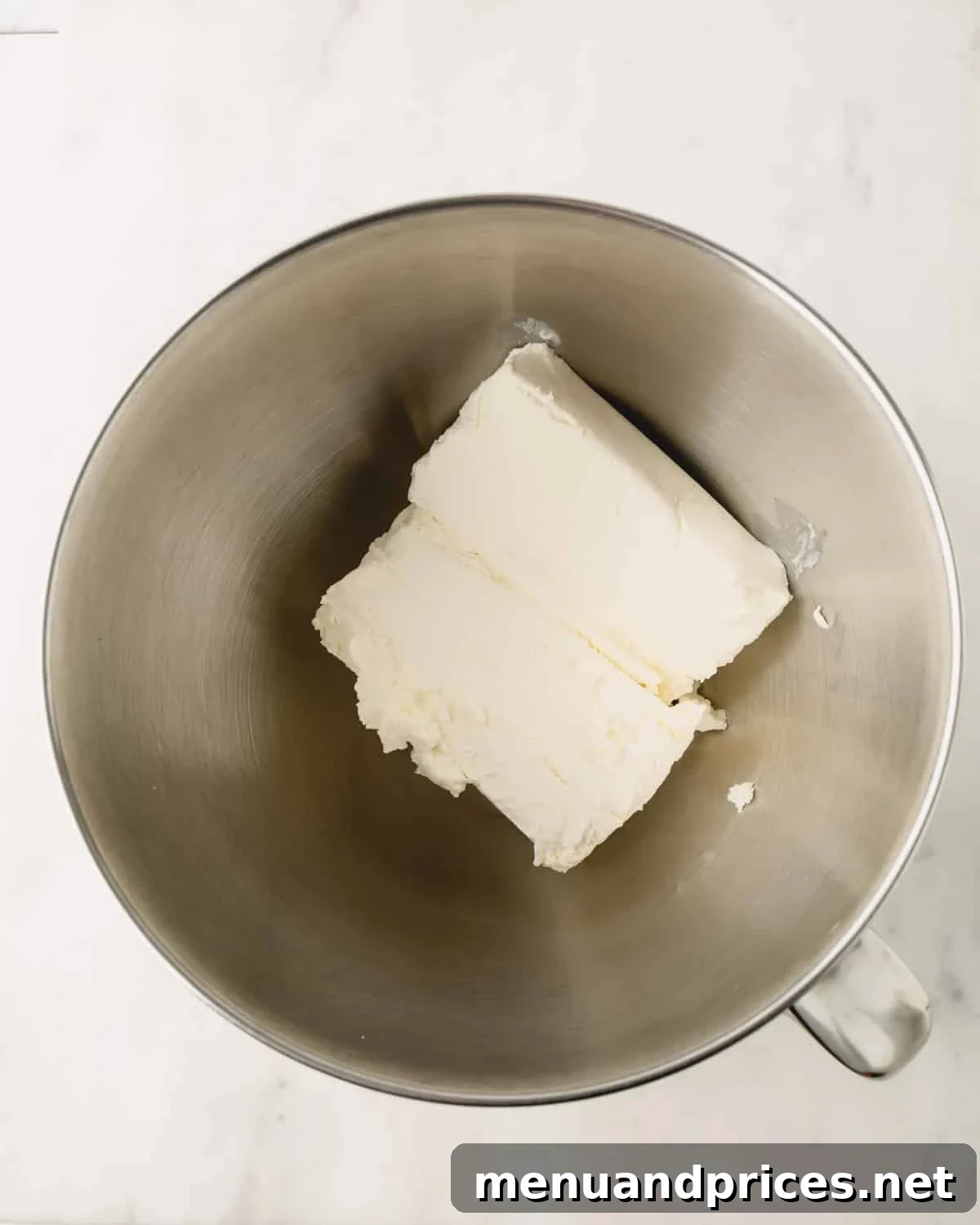 A stand mixer with cream cheese.