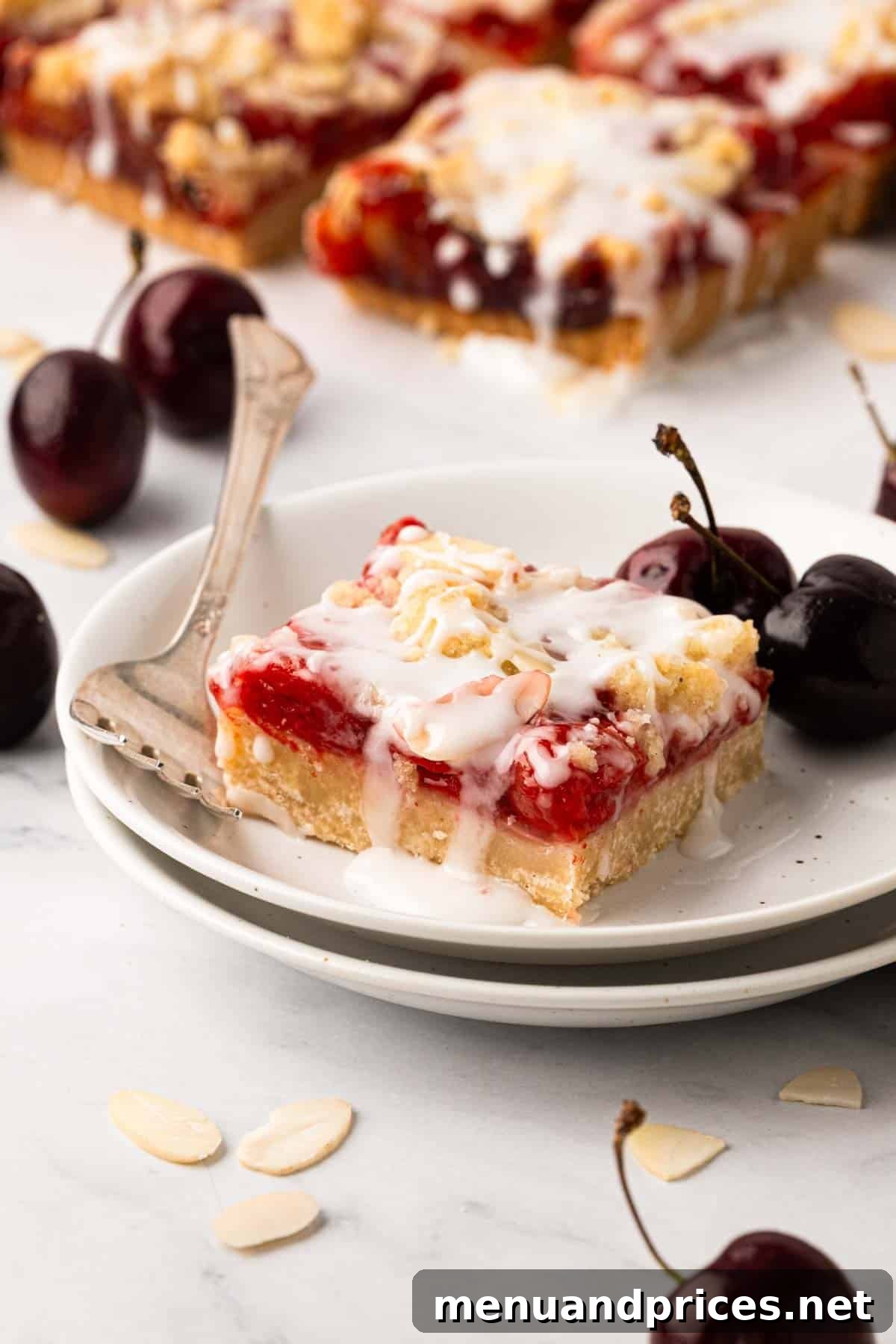 A cherry pie bar on a white plate with a fork.