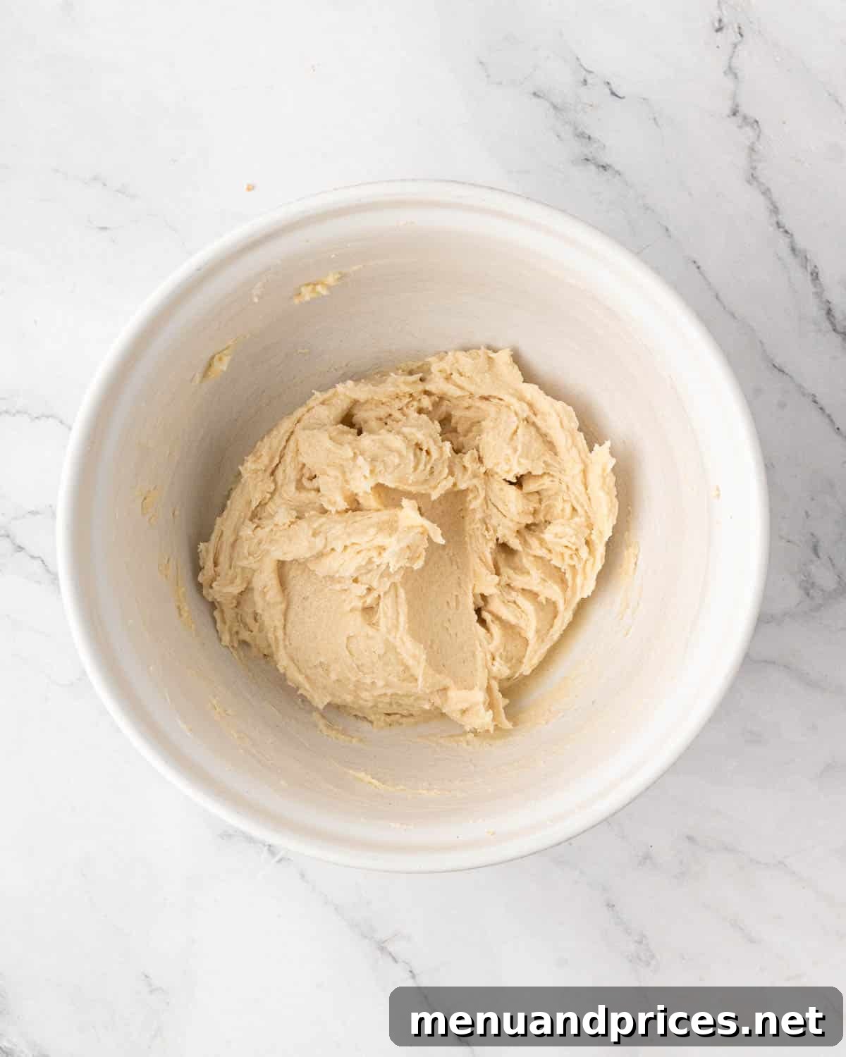 A white bowl with butter and sugar creamed.