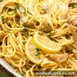 Close up image of lemon artichoke pasta in a white bowl.