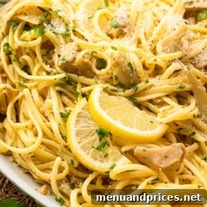 Close up image of lemon artichoke pasta in a white bowl.